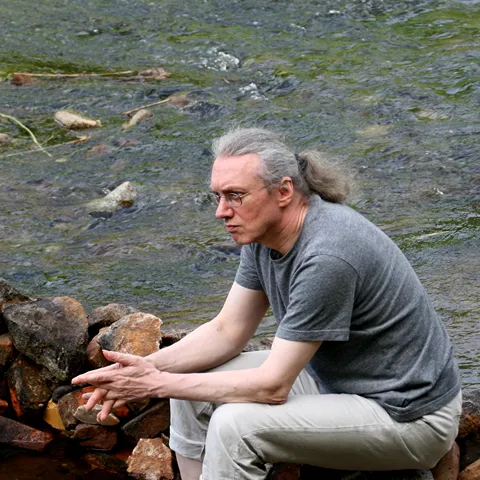 Lothar Rosengarten auf Steinen in der Neiße sitzend